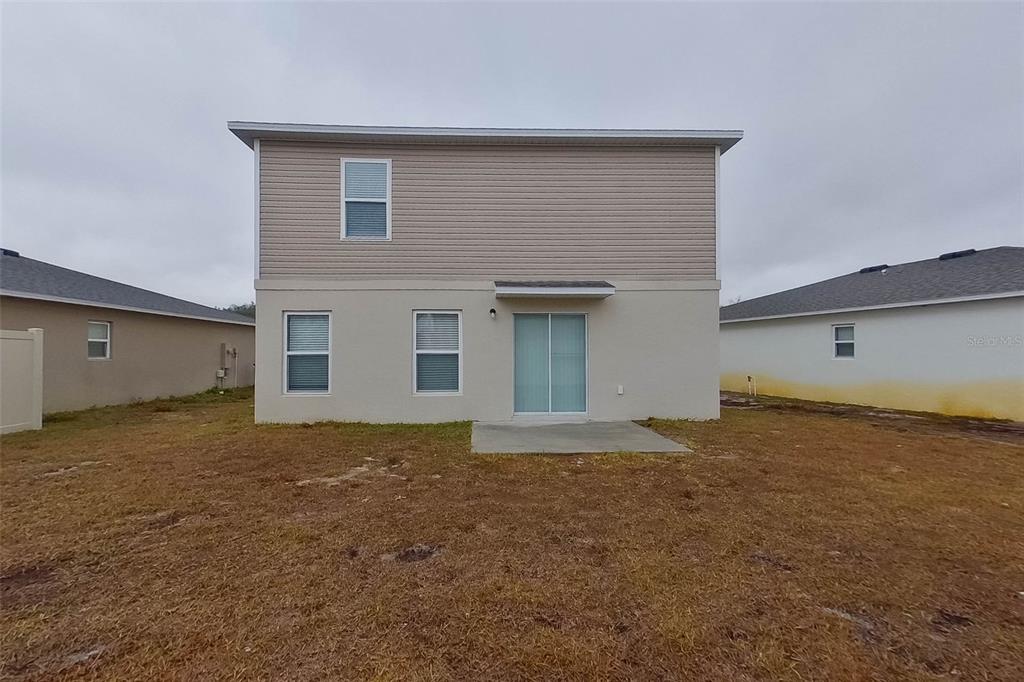 1709 Nebraska Loop Sumterville, FL 33585 - Photo 22 of 22 a view of backyard of house