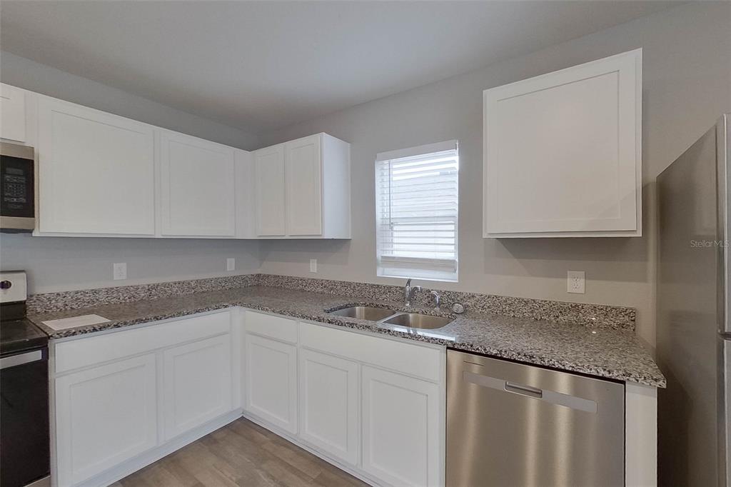 1709 Nebraska Loop Sumterville, FL 33585 - Photo 5 of 22 a kitchen with granite countertop cabinets sink and window