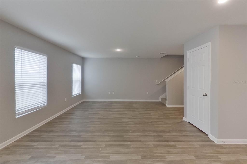 1709 Nebraska Loop Sumterville, FL 33585 - Photo 6 of 22 a view of an empty room with wooden floor and a window