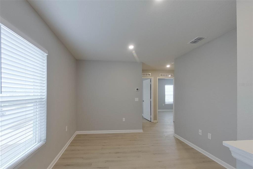 1709 Nebraska Loop Sumterville, FL 33585 - Photo 7 of 22 a view of hallway with a window and wooden floor