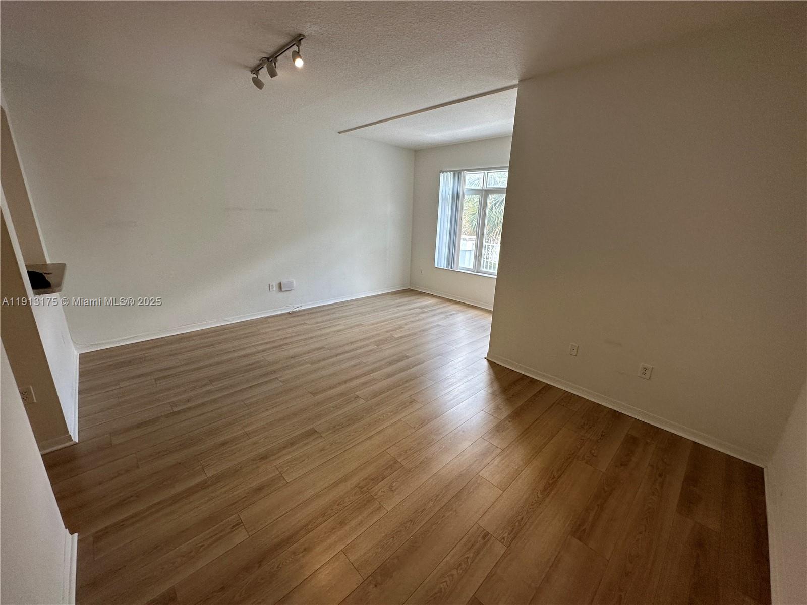1200 Town Center Drive, Unit 217 Jupiter, FL 33458 - Photo 24 of 37 wooden floor in an empty room with a window