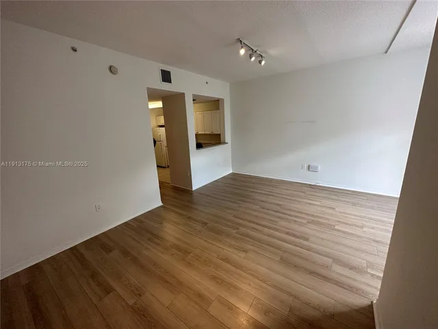 a view of a house with porch and wooden fence