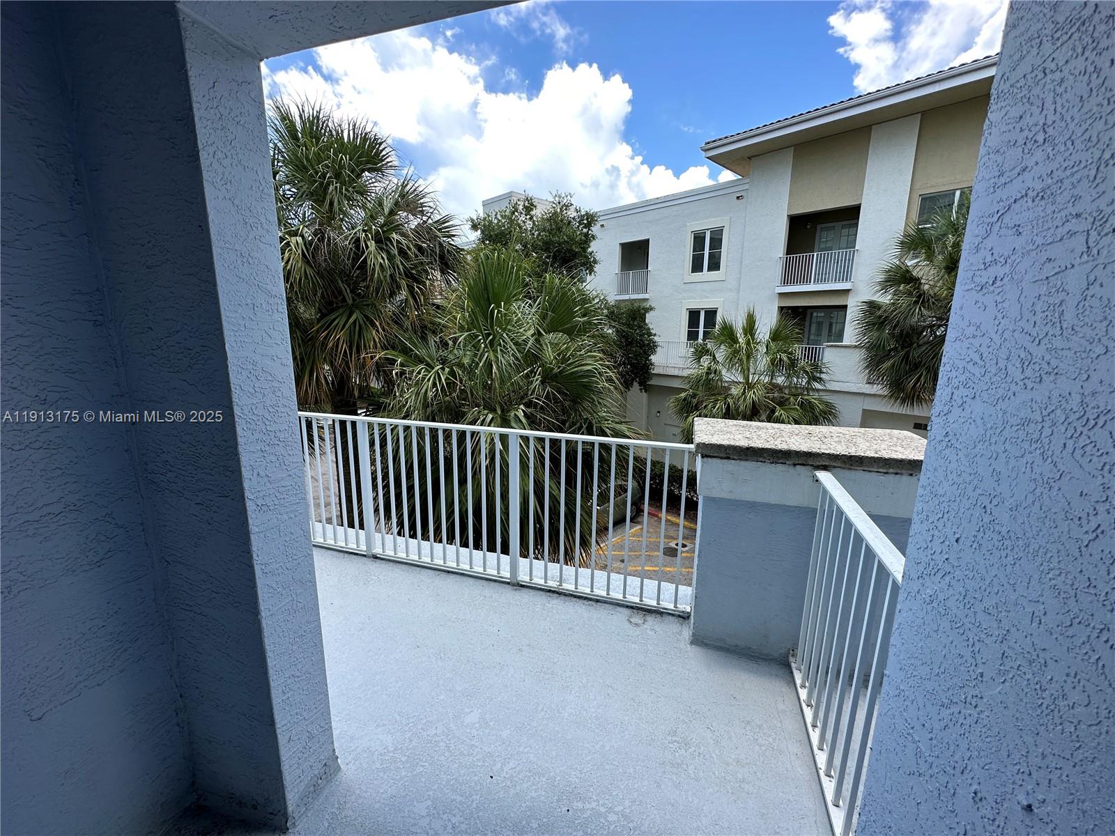 1200 Town Center Drive, Unit 217 Jupiter, FL 33458 - Photo 27 of 37 a view of a house with porch and wooden fence