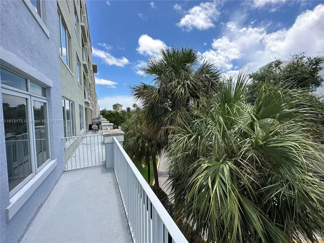 a hallway with sliding door and chandelier