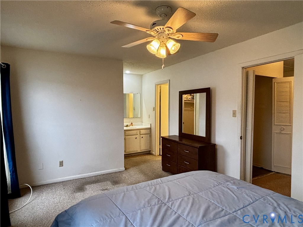 3860 Governors Way Virginia Beach, VA 23452 - Photo 14 of 22 a bedroom with a bed and a chandelier