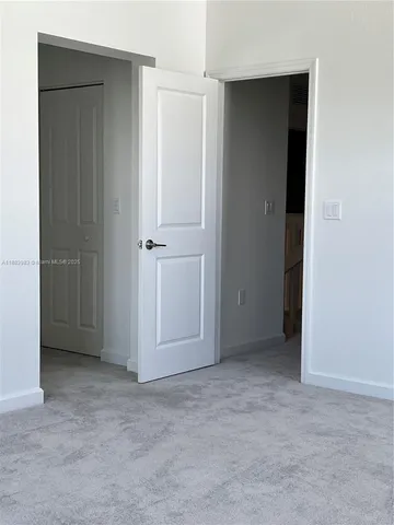 an empty room with closet area