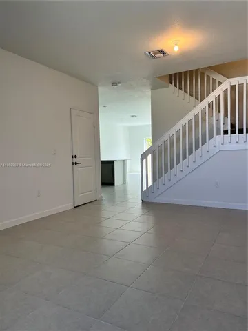 a view of staircase with white walls
