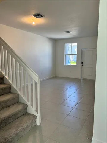 a view of an empty room with stairs