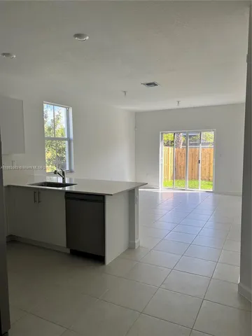 a view of a kitchen with a sink and a window