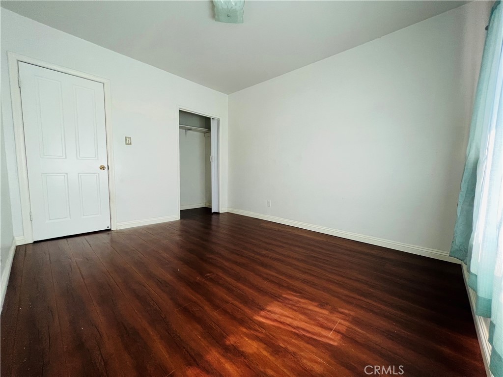 8051 Hellman Avenue Rosemead, CA 91770 - Photo 11 of 18 a view of an empty room with wooden floor and closet