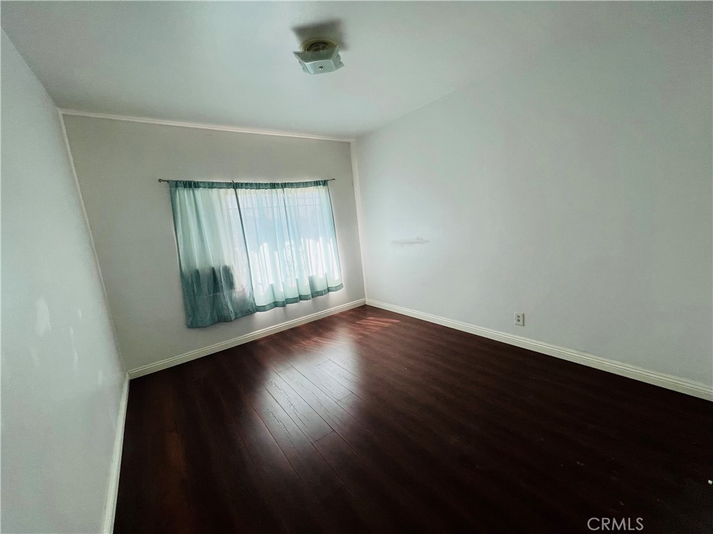 8051 Hellman Avenue Rosemead, CA 91770 - Photo 12 of 18 an empty room with wooden floor and windows
