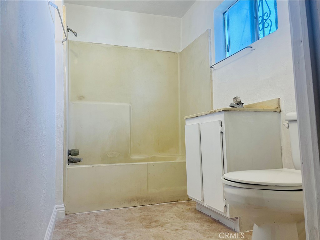 8051 Hellman Avenue Rosemead, CA 91770 - Photo 16 of 18 a bathroom with a granite countertop toilet and a shower