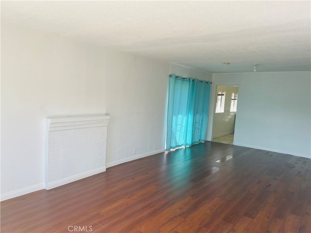 8051 Hellman Avenue Rosemead, CA 91770 - Photo 4 of 18 an empty room with wooden floor and windows