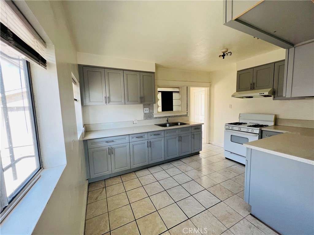 8051 Hellman Avenue Rosemead, CA 91770 - Photo 6 of 18 a kitchen with stainless steel appliances a stove a sink a microwave a refrigerator and cabinets