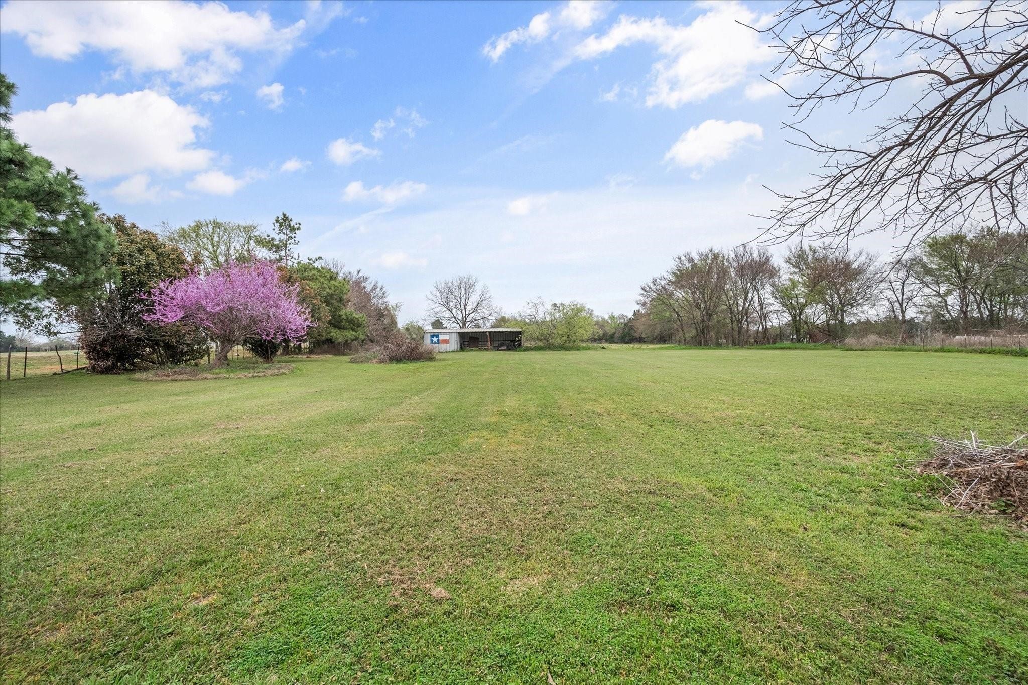 230 Freestone County Road, Unit 141 Streetman, TX 75859 - Photo 28 of 40 a backyard of a house with lots of green space and lake view