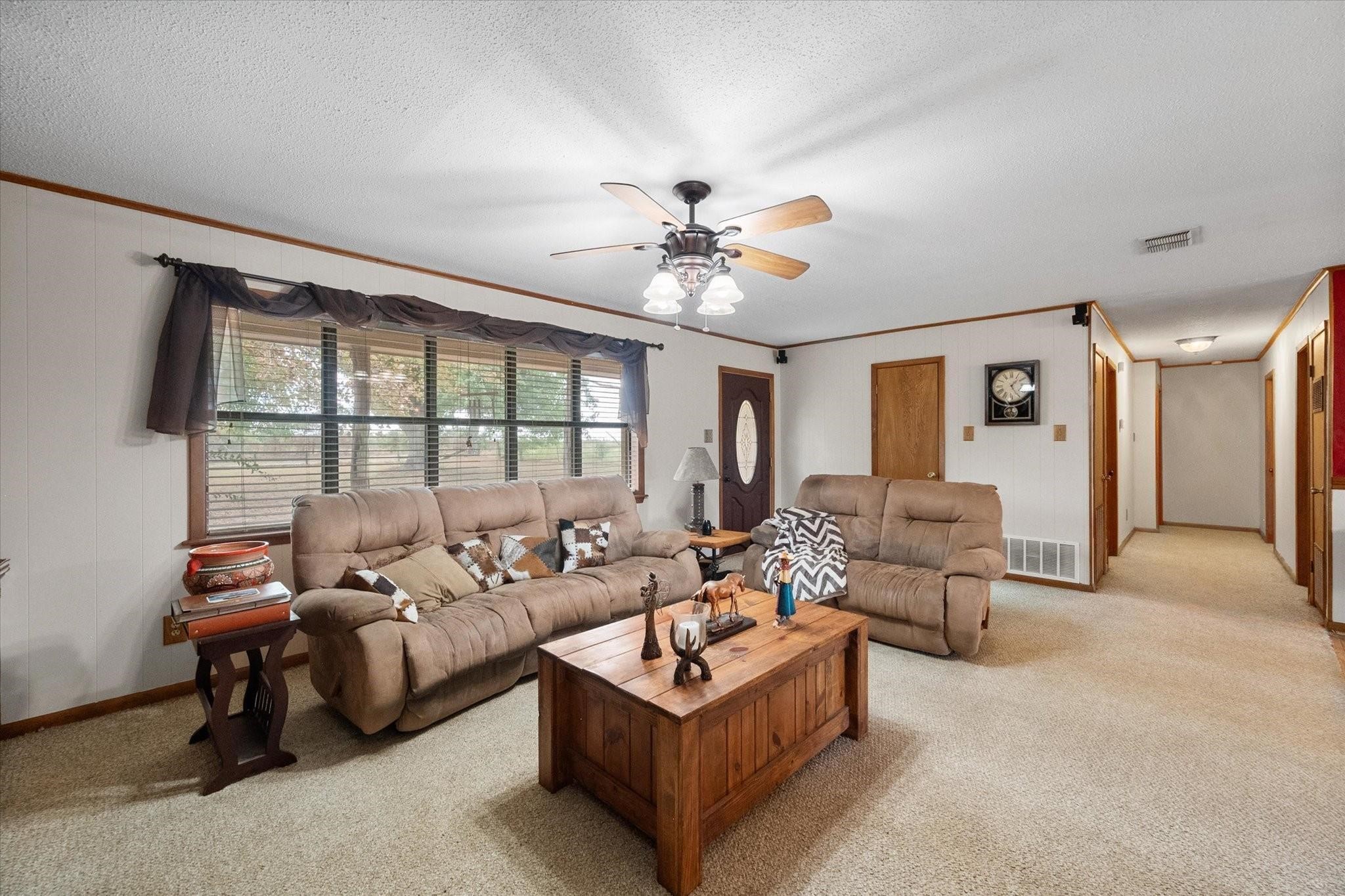 230 Freestone County Road, Unit 141 Streetman, TX 75859 - Photo 4 of 40 a living room with furniture and a large window