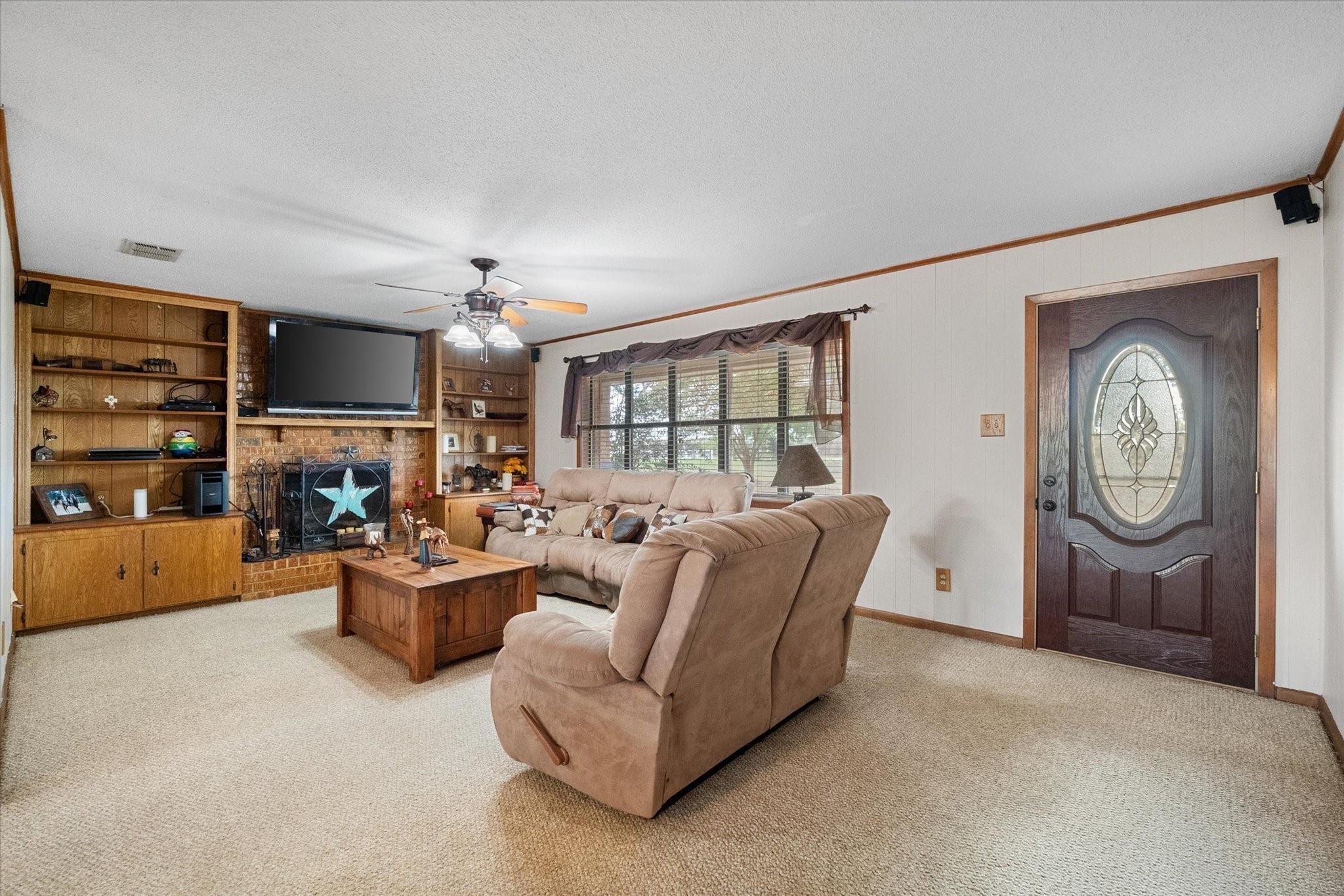 230 Freestone County Road, Unit 141 Streetman, TX 75859 - Photo 6 of 40 a living room with fireplace furniture and a window