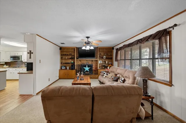 a living room with fireplace furniture and a chandelier