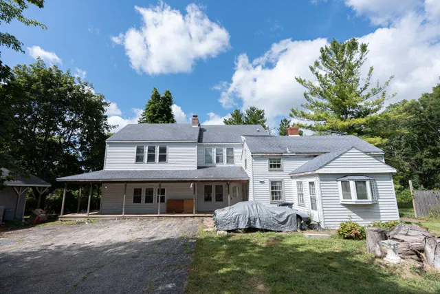 a front view of a house with a garden