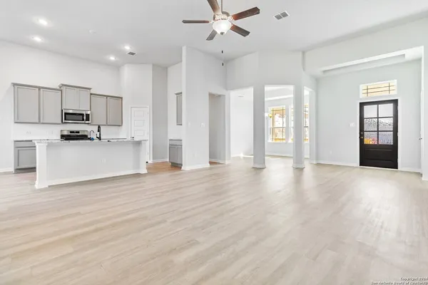 a view of a kitchen with a sink and a stove top oven