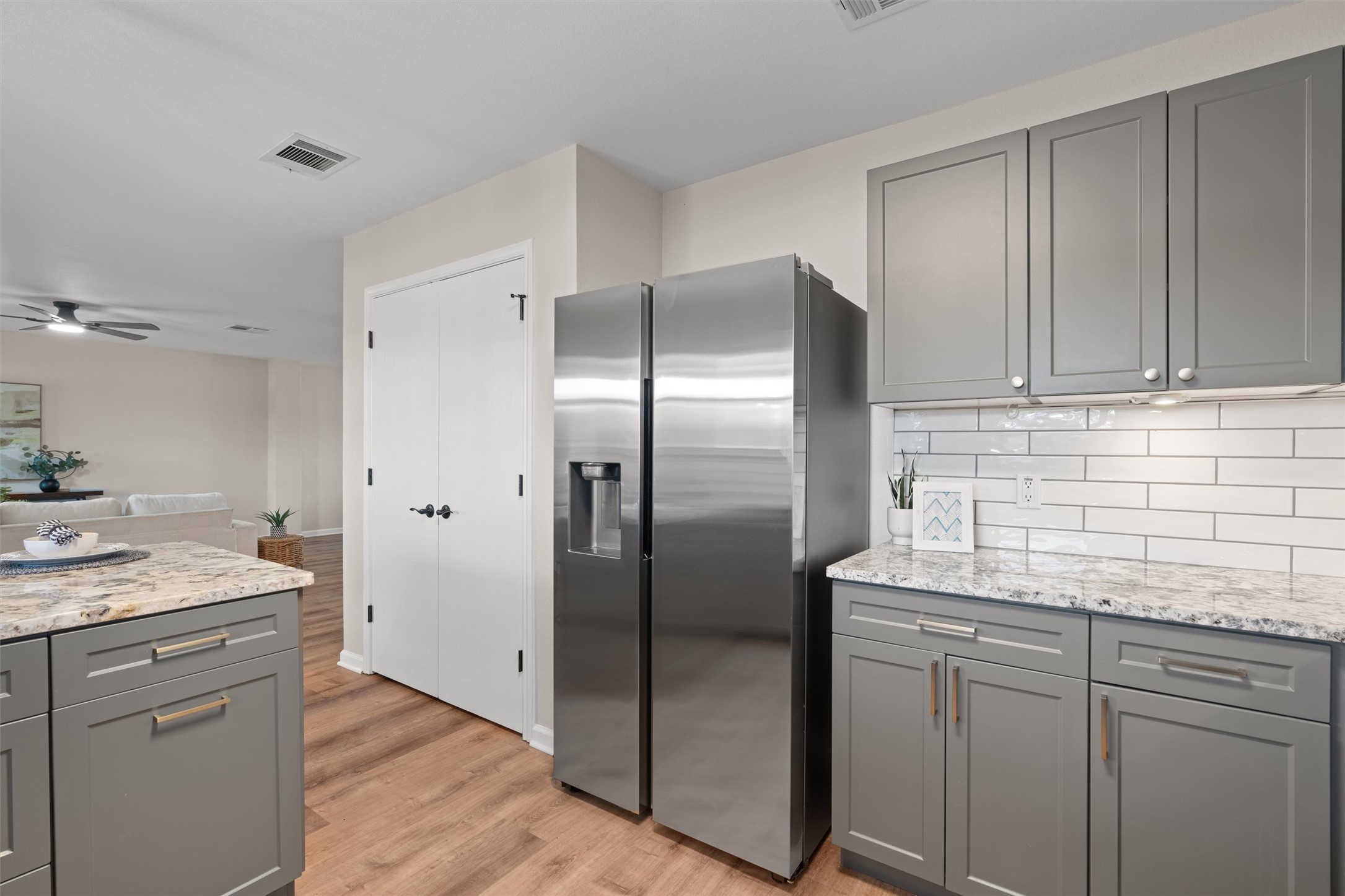 724 Lavaca Loop Elgin, TX 78621 - Photo 12 of 40 Polished stone countertops complement sleek shaker cabinetry in this open kitchen layout.