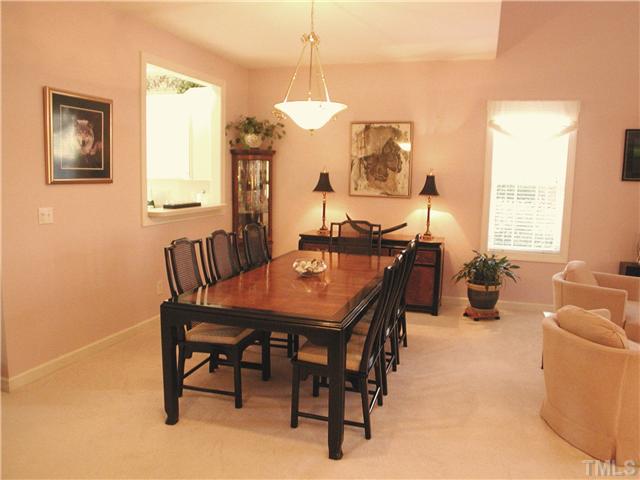 8730 Compass Lane Raleigh, NC 27615 - Photo 4 of 21 Dining area is spacious, with an attractive cased opening to the kitchen. The walls have been painted a neutral beige, the carpet has been replaced with a neutral beige tone as well.