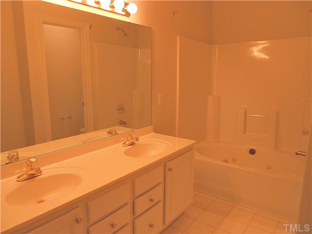 8730 Compass Lane Raleigh, NC 27615 - Photo 7 of 21 ...and adjoins this nicely-appointed master bath, featuring double vanities and a whirlpool tub/shower combination.