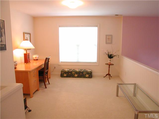 8730 Compass Lane Raleigh, NC 27615 - Photo 8 of 21 The upstairs loft gets wonderful natural light because the property is an end unit. It can serve multiple functions---office space, quiet reading spot, you name it.... The lavender wall color shown here have been replaced with neutral beige throughout.