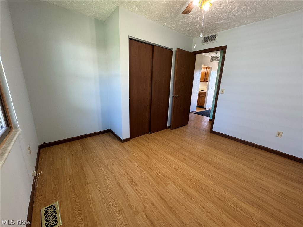 1763 Aberdeen Road Madison, OH 44057 - Photo 24 of 31 Unfurnished bedroom with a closet, ceiling fan, and light hardwood / wood-style floors