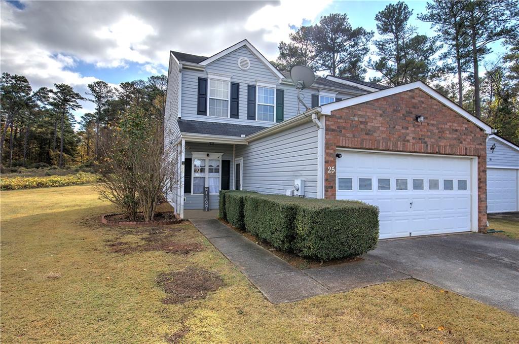 a front view of a house with a garden