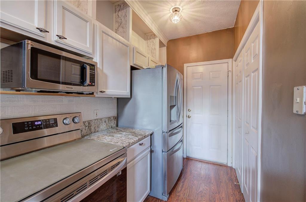 25 Haley Place, Unit 3 Cartersville, GA 30121 - Photo 11 of 45 a kitchen with stainless steel appliances granite countertop a refrigerator and a stove top oven