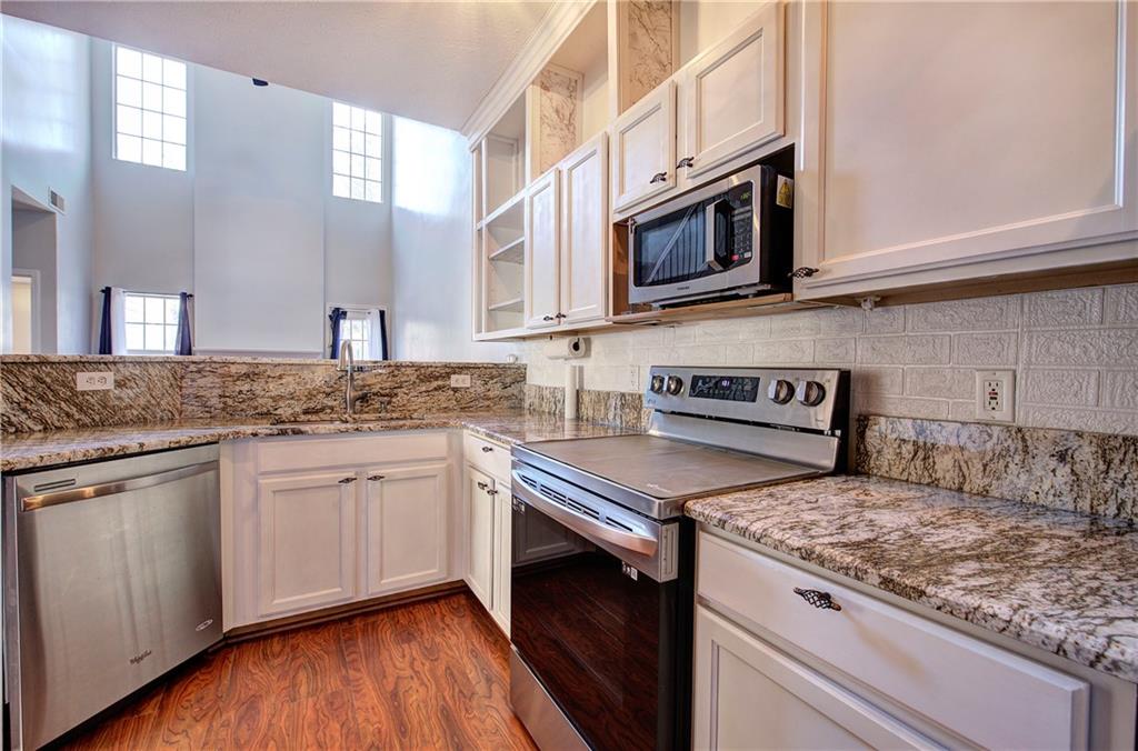 25 Haley Place, Unit 3 Cartersville, GA 30121 - Photo 13 of 45 a kitchen with stainless steel appliances granite countertop a stove and a microwave