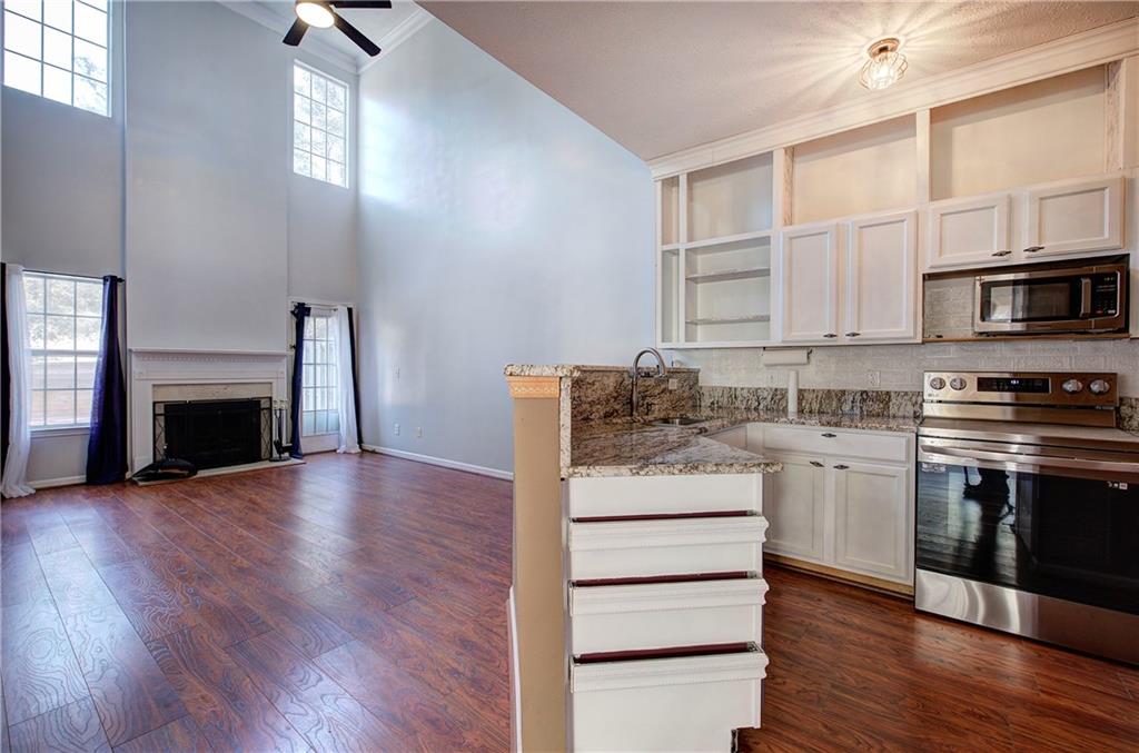 25 Haley Place, Unit 3 Cartersville, GA 30121 - Photo 14 of 45 a kitchen with granite countertop a stove top oven and sink