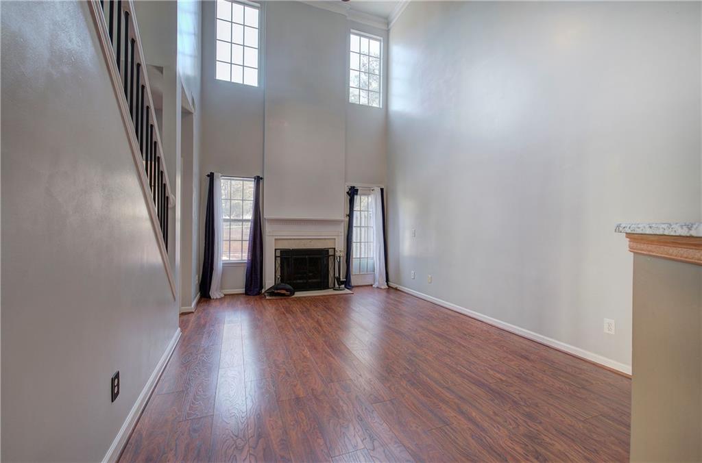 25 Haley Place, Unit 3 Cartersville, GA 30121 - Photo 15 of 45 an empty room with wooden floor and fireplace