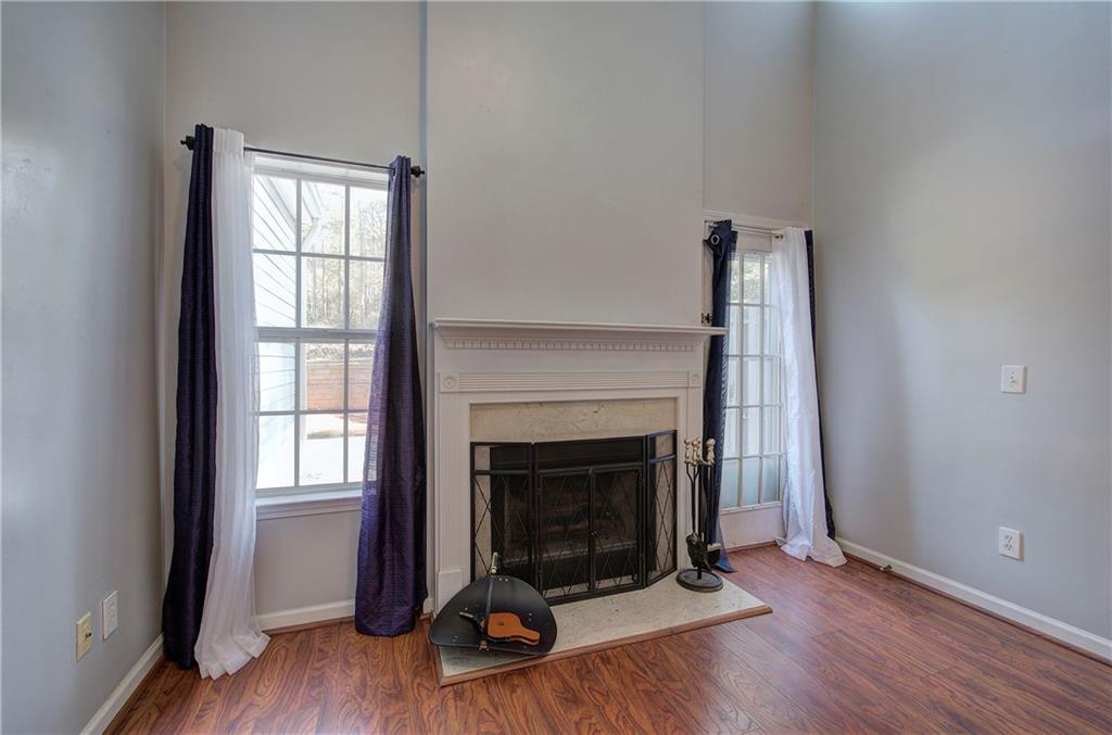 25 Haley Place, Unit 3 Cartersville, GA 30121 - Photo 16 of 45 an empty room with wooden floor and fireplace