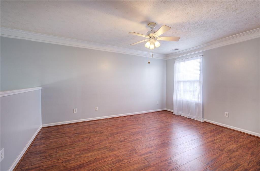 25 Haley Place, Unit 3 Cartersville, GA 30121 - Photo 26 of 45 an empty room with wooden floor fan and windows