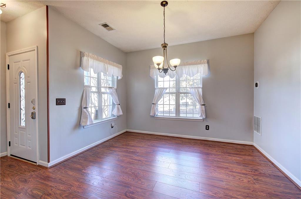 25 Haley Place, Unit 3 Cartersville, GA 30121 - Photo 3 of 45 a view of an empty room with wooden floor and a window