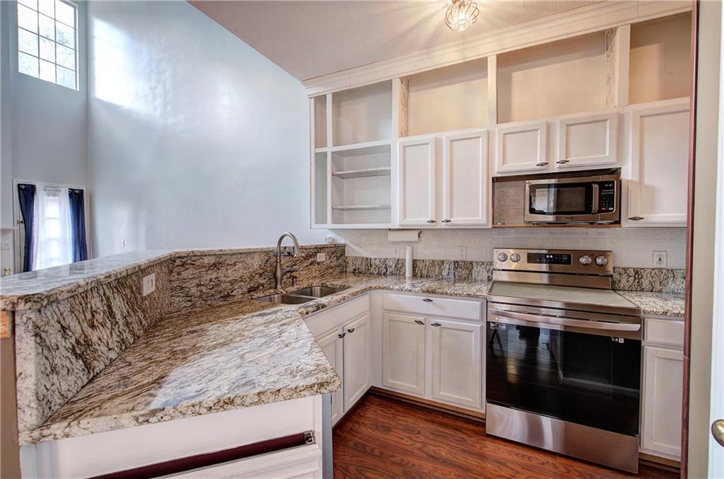 25 Haley Place, Unit 3 Cartersville, GA 30121 - Photo 9 of 45 a kitchen with stainless steel appliances granite countertop a stove and a sink