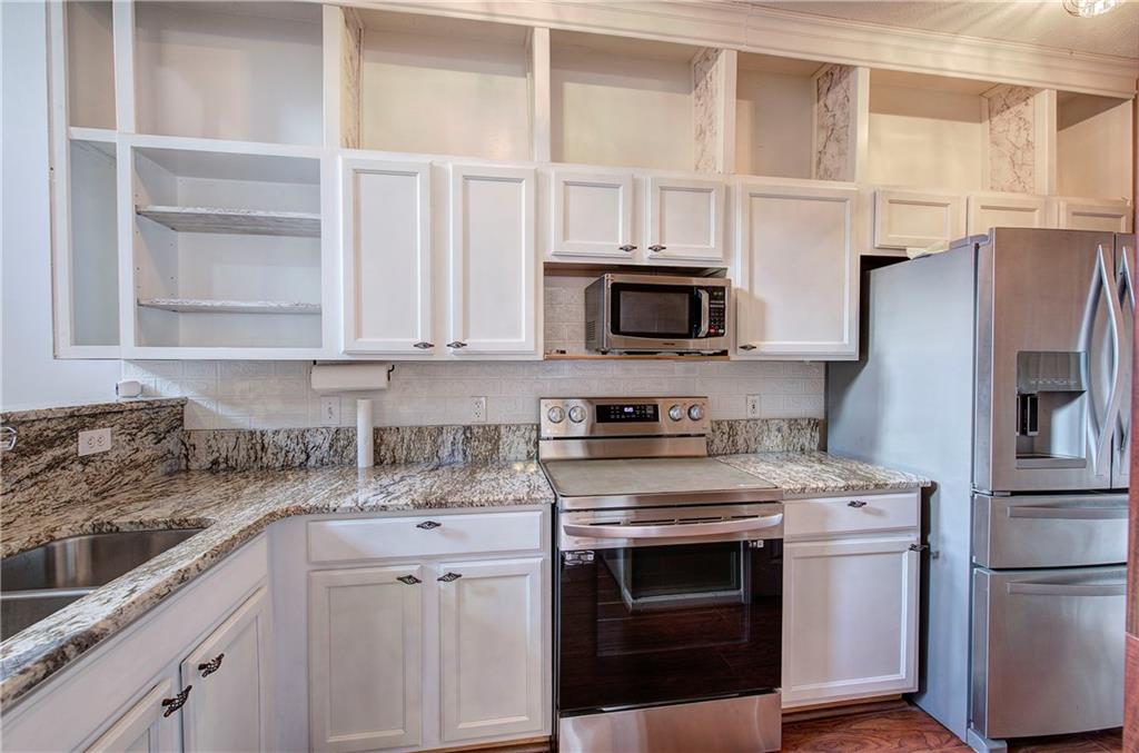 25 Haley Place, Unit 3 Cartersville, GA 30121 - Photo 10 of 45 a kitchen with stainless steel appliances granite countertop white cabinets and a stove