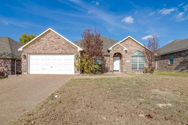 a view of a house with a yard and garage