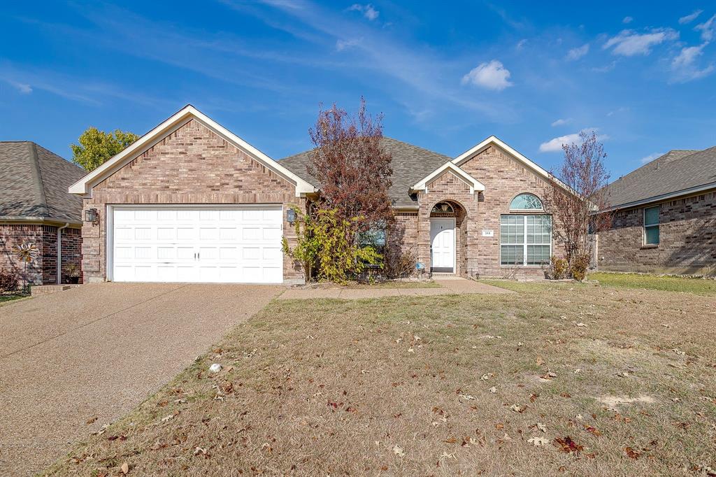 a view of a house with a yard and garage