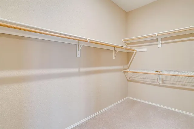 an empty room with chandelier fan