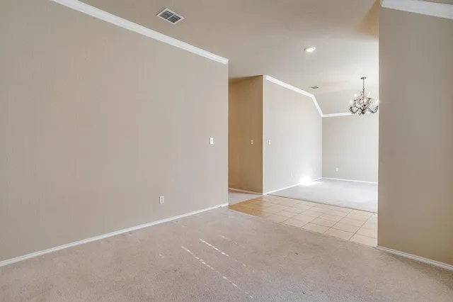 an empty room with a window and a ceiling fan