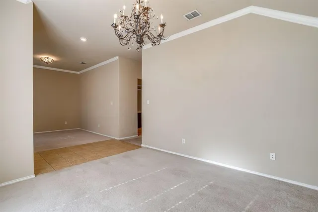 an empty room with windows and fireplace