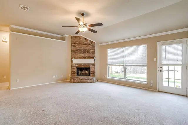 a view of an empty room with a fireplace
