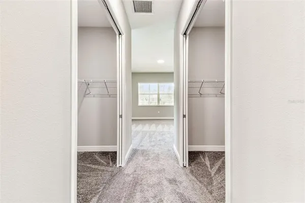 a view of a hallway with wooden shelves