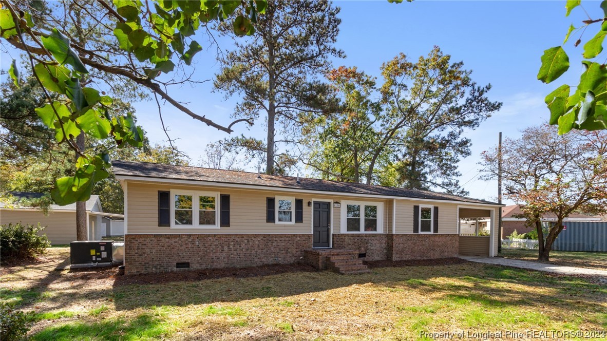 6114 Sandy Creek Road Stedman, NC 28391 - Photo 1 of 34 a front view of a house with a yard
