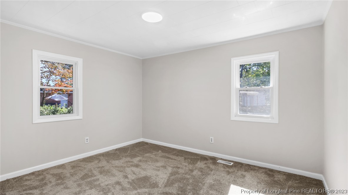 6114 Sandy Creek Road Stedman, NC 28391 - Photo 12 of 34 an empty room with windows