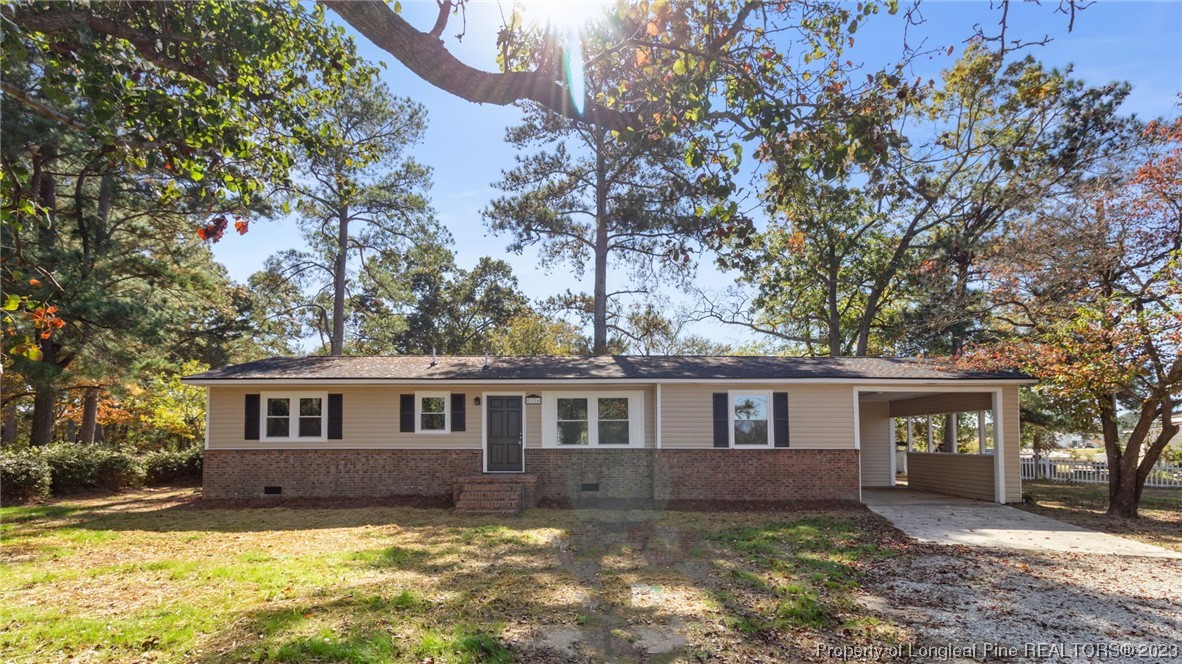 6114 Sandy Creek Road Stedman, NC 28391 - Photo 2 of 34 a front view of a house with a yard