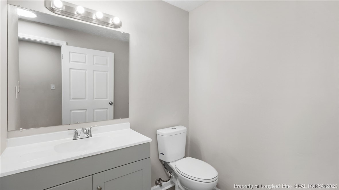 6114 Sandy Creek Road Stedman, NC 28391 - Photo 22 of 34 a bathroom with a sink a toilet and vanity